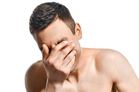Closeup portrait of stressed despair man isolated on white backgroundの写真素材
