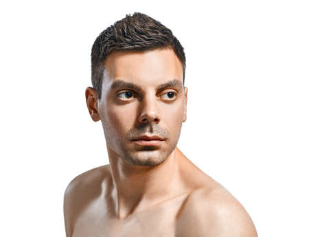 Closeup portrait of handsome man with healthy clean skin isolated on white background with copy spaceの写真素材