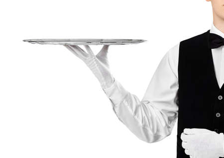 Elegant waiter holding empty silver tray on hand isolated on white backgroundの写真素材