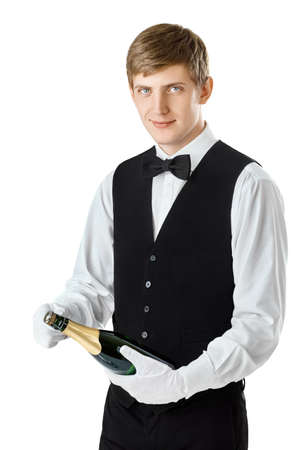 Portrait of young handsome waiter opening bottle of champagne isolated on white backgroundの写真素材