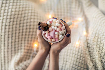 Top view of woman hands with cup of hot chocolate and marshmallows. New Year conceptの写真素材
