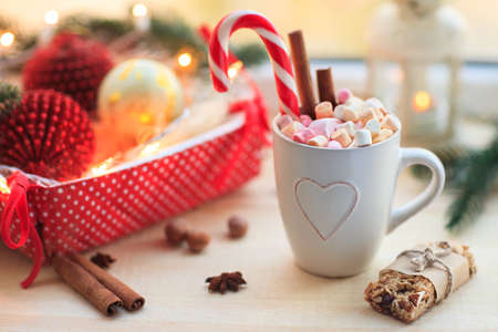Christmas background with cup of chocolate, marshmallow and festive decoration. Winter holiday conceptの写真素材