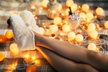 Woman feet in woollen socks and cup of hot chocolate. relax holidays conceptの写真素材
