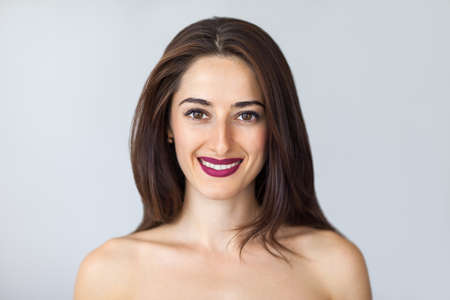 natural portrait of a young smiling womanの写真素材