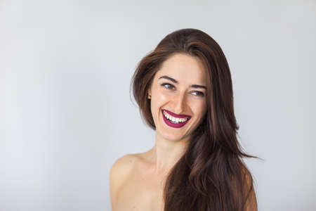 natural portrait of a young smiling womanの写真素材