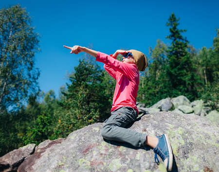 %u0421ute little girl pointing direction hand up in mountain.の写真素材