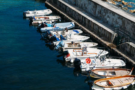Motor boats and sailboats in harbor.の写真素材