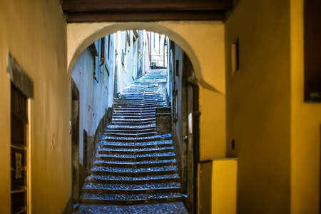 Beautiful old narrow stairs and arch on Italy streetの写真素材