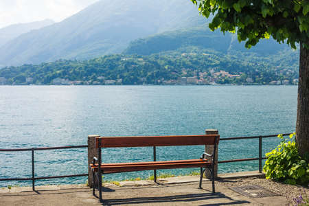 Wooden bench on Lake Como, Italy.の写真素材