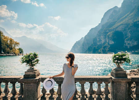 Young beautiful woman relaxing on picturesque Garda Lake. Vacation conceptの写真素材