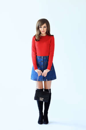 Full length fashion portrait of shy beautiful woman in retro style on white backgroundの写真素材