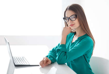 Confident business woman with laptop in the office. Business conceptの写真素材