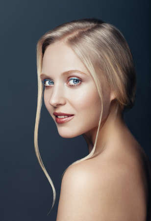 Beauty close up portrait of nordic natural blonde woman on dark backgroundの写真素材
