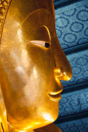 Close up face of big reclining buddha at Wat Pho temple in Bangkok, Thailandの写真素材