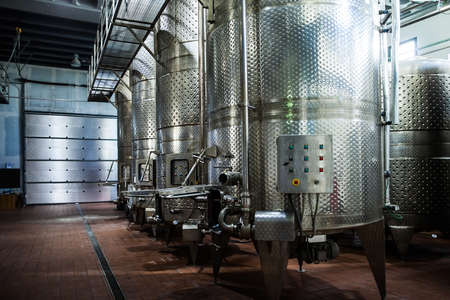 Metal tanks in a row inside the winery factoryの写真素材