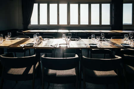 Served table with dishes and glasses in tasting room in a winery restaurantの写真素材