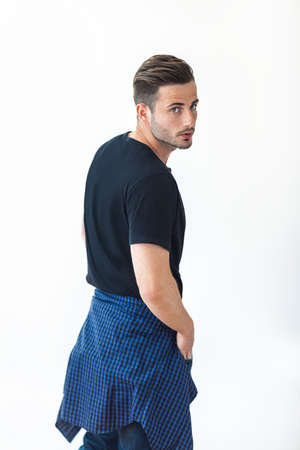 Handsome sexy man in stylish casual clothes standing against white backgroundの写真素材