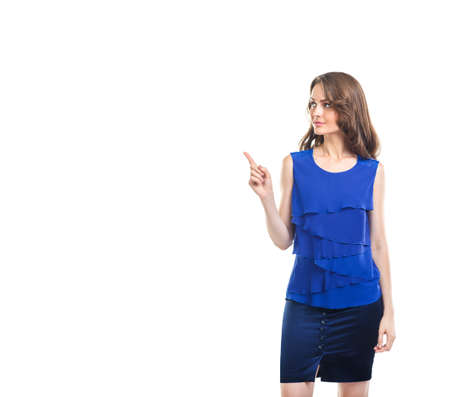 Young beautiful woman pointing copy space isolated on white background. Full length portraitの写真素材