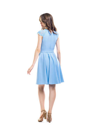 Back view of young beautiful woman in blue dress isolated on white backgroundの写真素材