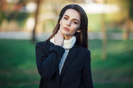 Young beautiful woman portrait posing in city park on sunset. beauty conceptの写真素材