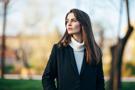 Beautiful woman portrait in the city park at sunset timeの写真素材