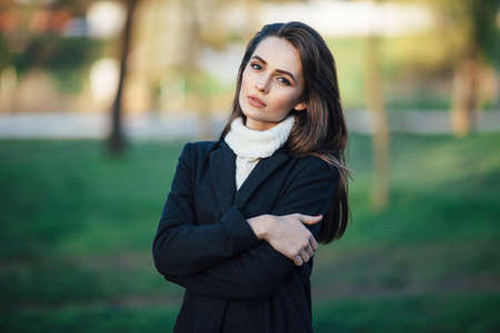 Young beautiful woman portrait posing in city park on sunset. beauty conceptの写真素材