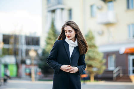 Beautiful shy woman standing in city street. Urban lifeの写真素材