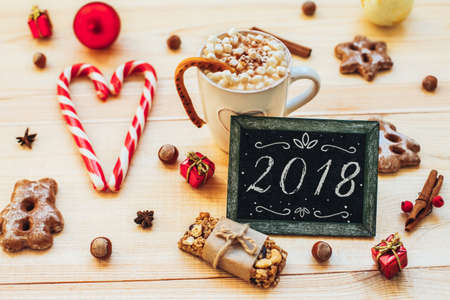 yummy New Year background. Christmas cookies and blackboard with festive decoration on wood.の写真素材