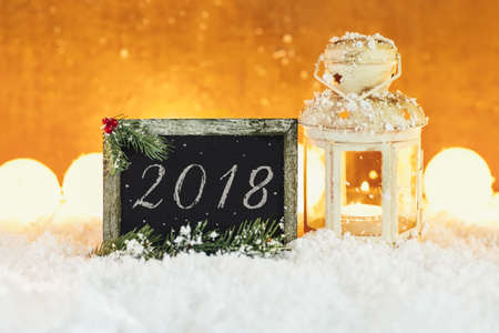 Christmas card 2018 with lantern and blackboard in snowの写真素材