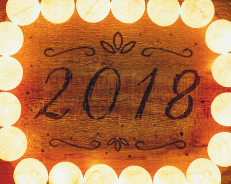 Lights frame on wooden background with copy space. Decorative garlandの写真素材
