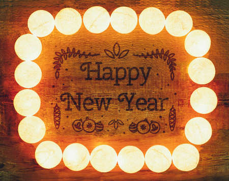 Lights frame on wooden background with copy space. Decorative garlandの写真素材