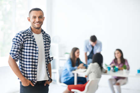 Successful businessman in front of diverse business team in modern officeの写真素材