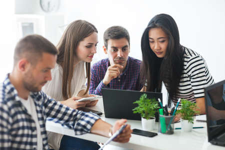 Group of business people sharing their ideas in modern office. Teamwork people conceptの写真素材