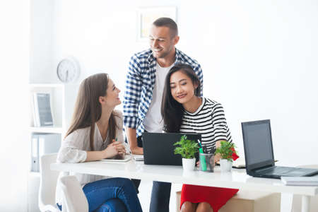 Smiling business people sharing their ideas in modern office. Teamwork people conceptの写真素材