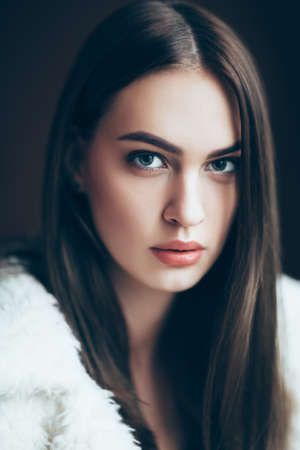 Young beautiful woman portrait, close-up. Pretty girl looking in camera, with red lipstick and...