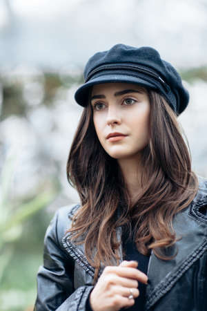 Fashion portrait of stylish pretty woman in black rock style on nature backgroundの写真素材