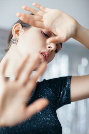 Beauty woman making stop gesture with her hands. Young frightened girl trying to stop danger. Prohibition symbolの写真素材