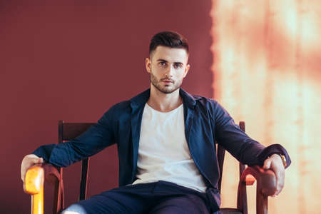 Portrait of handsome sexy man relax on sofa. Fashion portraitの写真素材