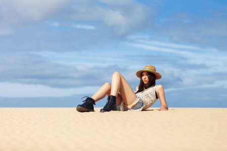 Beautiful hippie woman relaxing on sand. Fashion portrait. Vacation conceptの写真素材