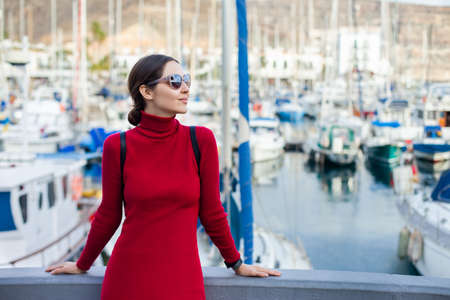 Young beautiful woman enjoying summer vacation in a small fishing port of Puerto de Mogan, Gran Canaria, Spain. Summer holidays conceptの写真素材