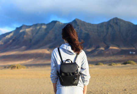 Back view of traveler woman enjoying beautiful mountains landscape. Canary islands, Spain. Tourism conceptの写真素材