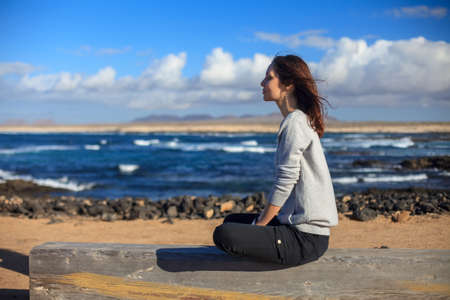Profile view of young woman relax on ocean beach. Vacation. Beach holidays