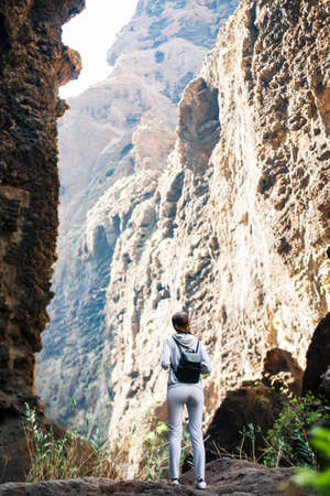 Traveler woman enjoy amazing Masca Gorge landscape during hiking route, Tenerife, Canary Islands. Travel destination. Active vacation conceptの写真素材