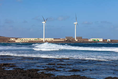 Modern windmills on the beach. Landscape with nature and technologyの写真素材