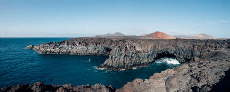 Panorama landscape of unique lava's caves Los Hervideros and ocean in Lanzarote island. Volcanic beach. Nature background. Canary Islands. Spainの写真素材