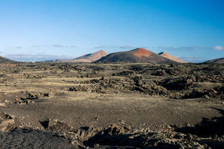 Unique volcanic landscapes of Timanfaya National Park, Lanzarote, Canary island. Nature background. Red and black volcanic mountains.の写真素材