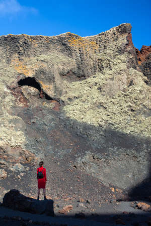 Traveler woman enjoy amazing mountain landscape,  Lanzarote, Canary Islands. Active vacation conceptの写真素材