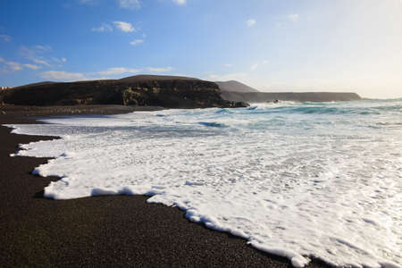 Scenic black sandy beach and ocean waves in Lanzarote, Canary islands, Spain.Travel destinationの写真素材