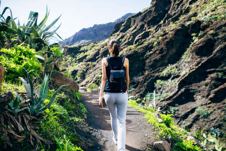 Hiking woman in the mountains. Masca valley, Tenerife, Canary islands, Spain. Active vacation conceptの写真素材