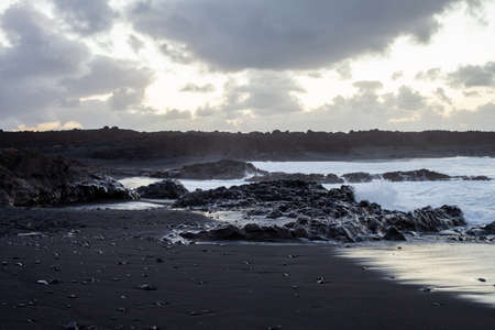 The black sand beach of Lanzarote on sunset. Nature background. Canary islands, Spainの写真素材
